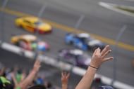 Fans raise three fingers to salute the late Dale Earnhardt on Lap 3 of the 2021 Daytona 500. Source: Imagn